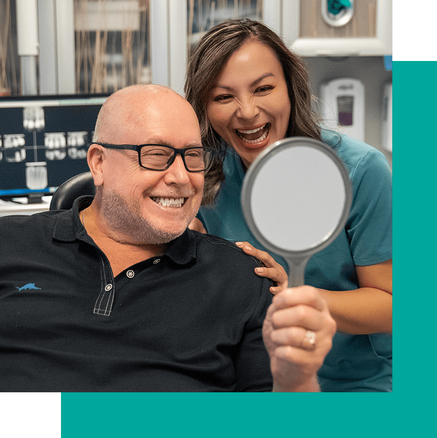 patient with mirror looking at smile reveal