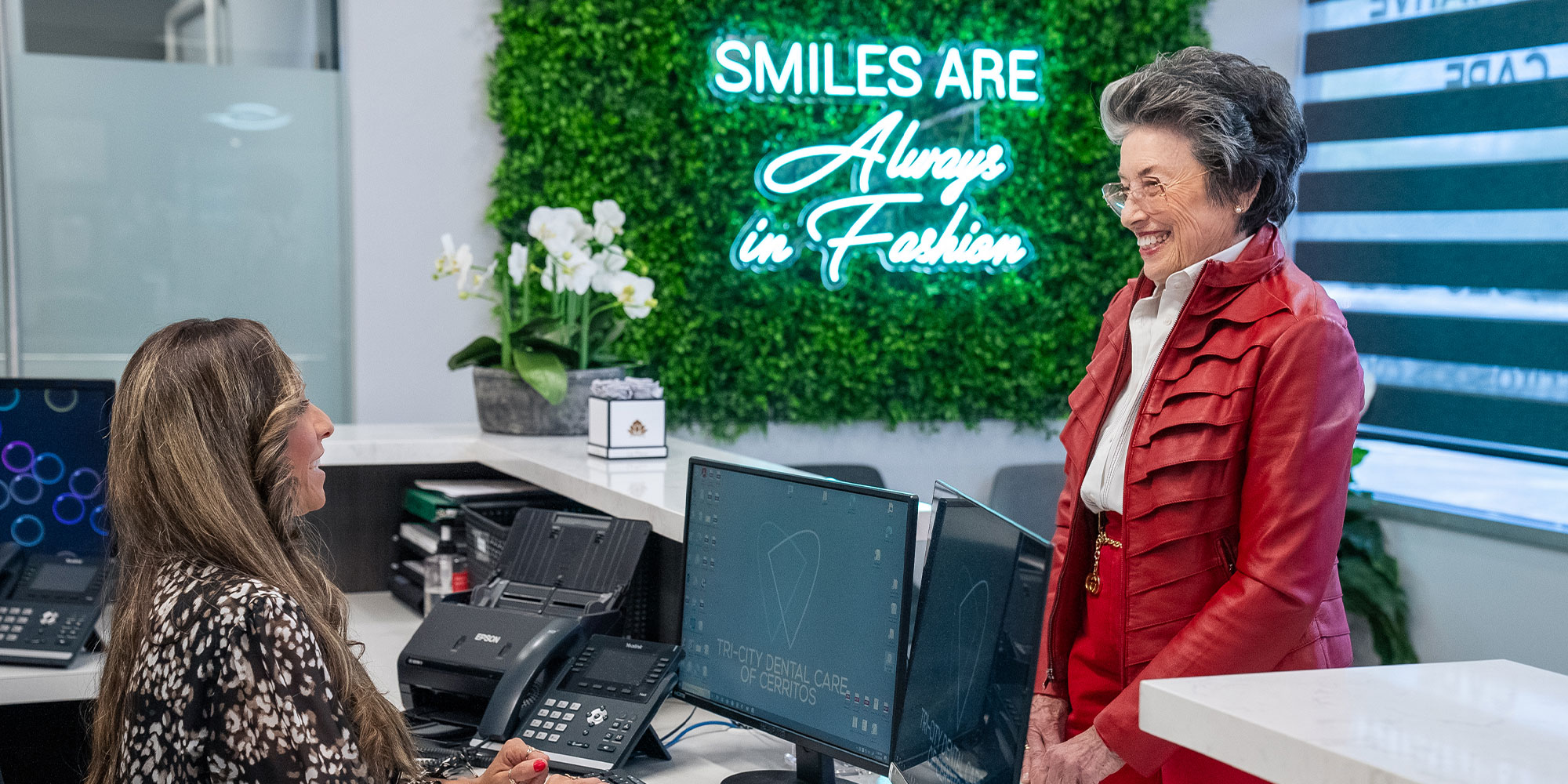 lady being thanked at front desk