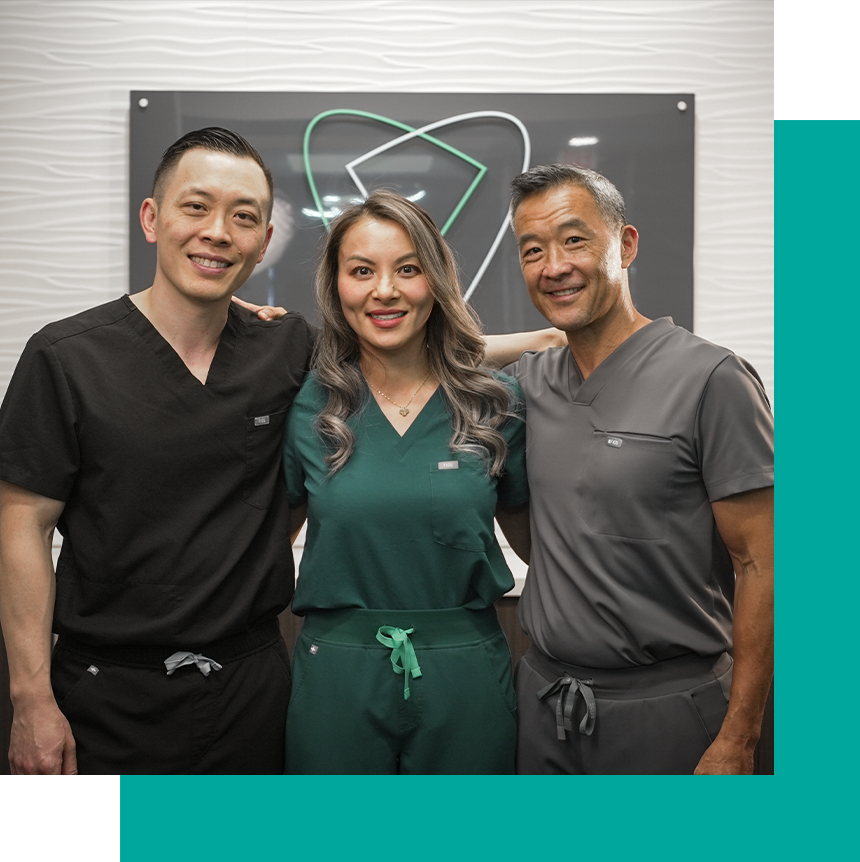 Dr. Chin, Dr. Wong and Dr. Dinh all smiling together with arms around each other