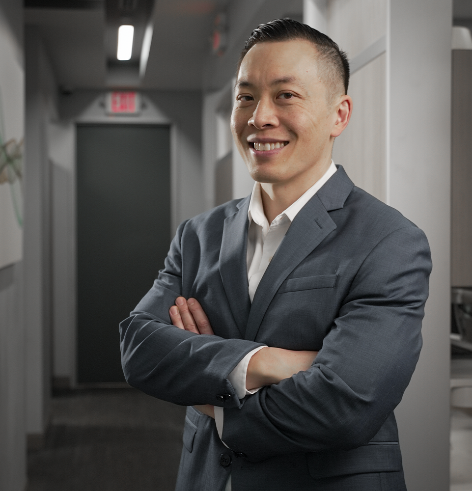 Dr Wong standing in office with his hands folded