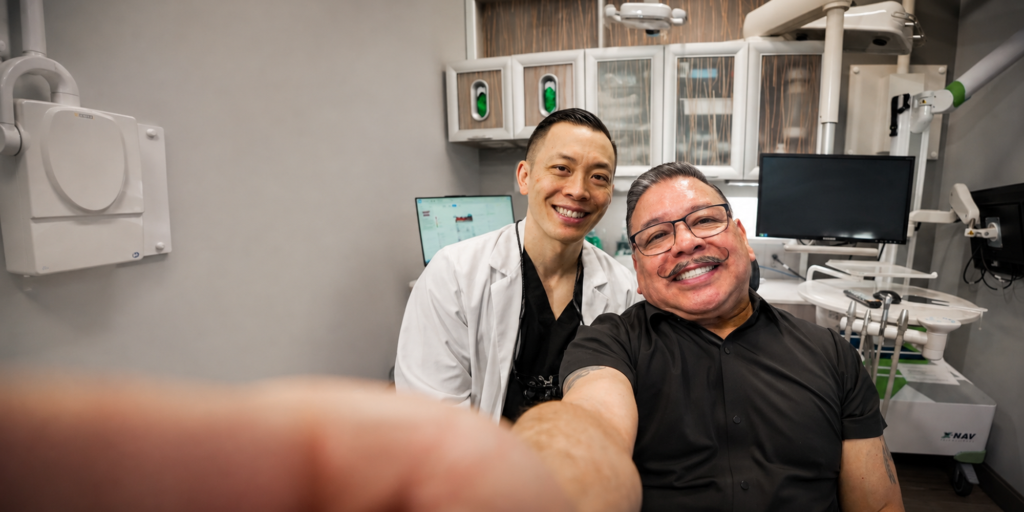 Dr. Wong smiling with his patient who is holding the camera
