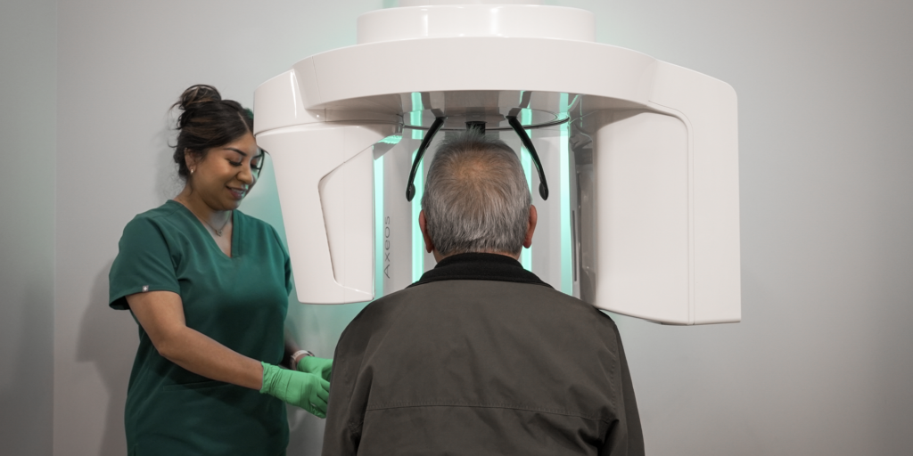 staff member performing a CBCT scan on a male patient