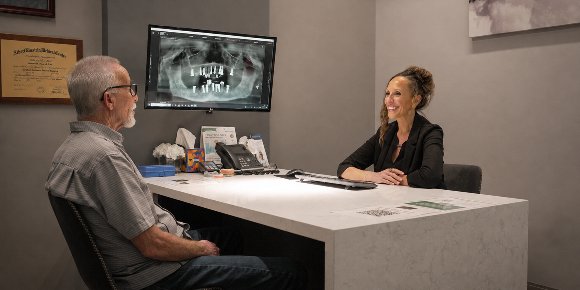 staff member smiling sitting across from patient in treatment planning room
