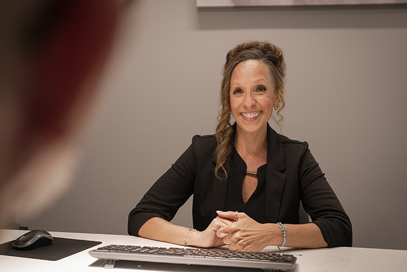 staff member smiling across form a patient in the treatment planning room